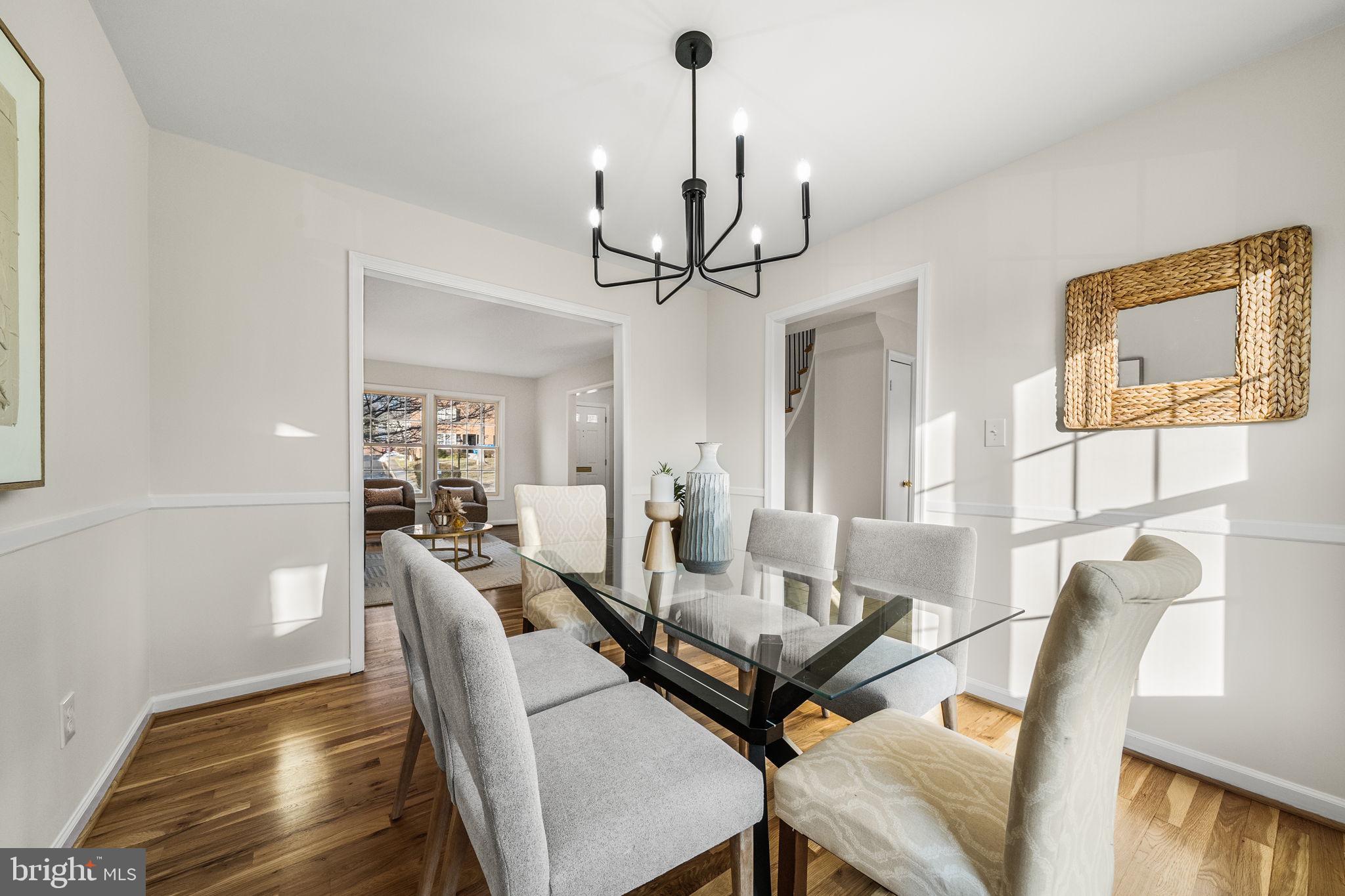 8333 Garfield Court Springfield, VA 22152 - Photo 14 of 60 a view of a dining room with furniture and a chandelier