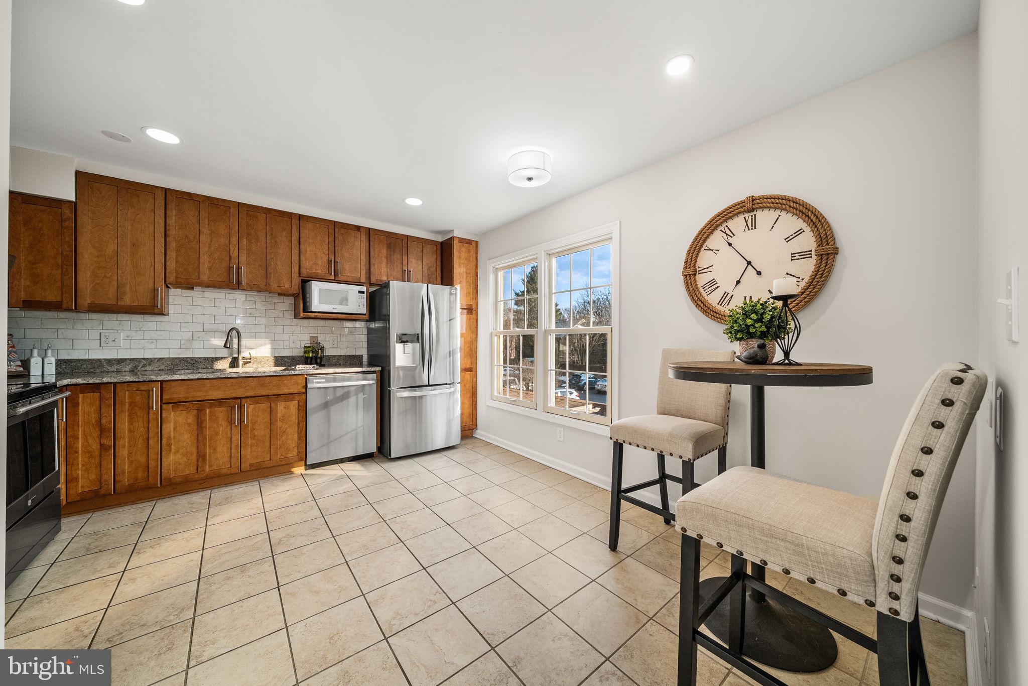 8333 Garfield Court Springfield, VA 22152 - Photo 19 of 60 a kitchen with furniture a refrigerator and a view of living room