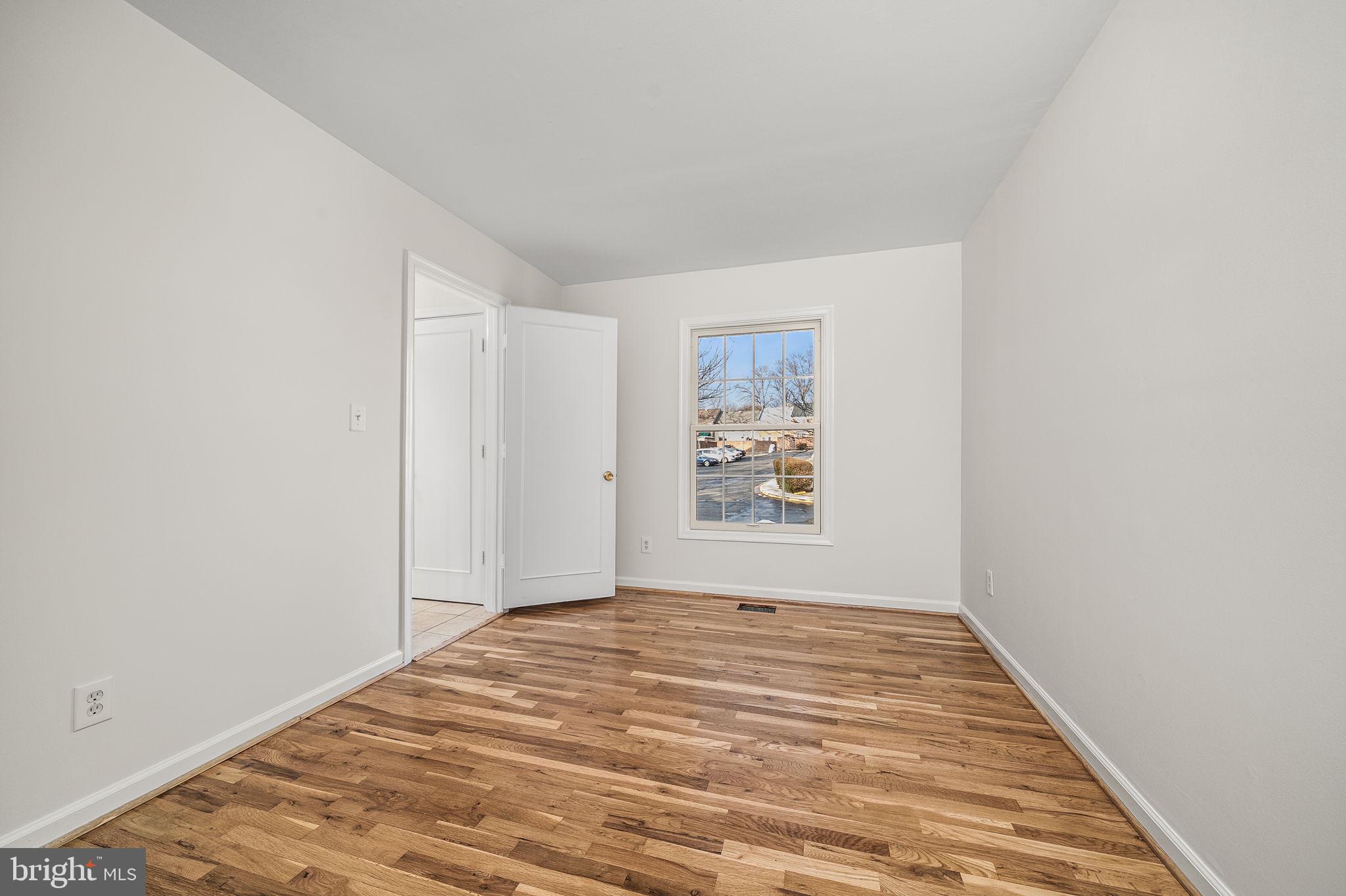8333 Garfield Court Springfield, VA 22152 - Photo 23 of 60 a view of a room with a window and wooden floor