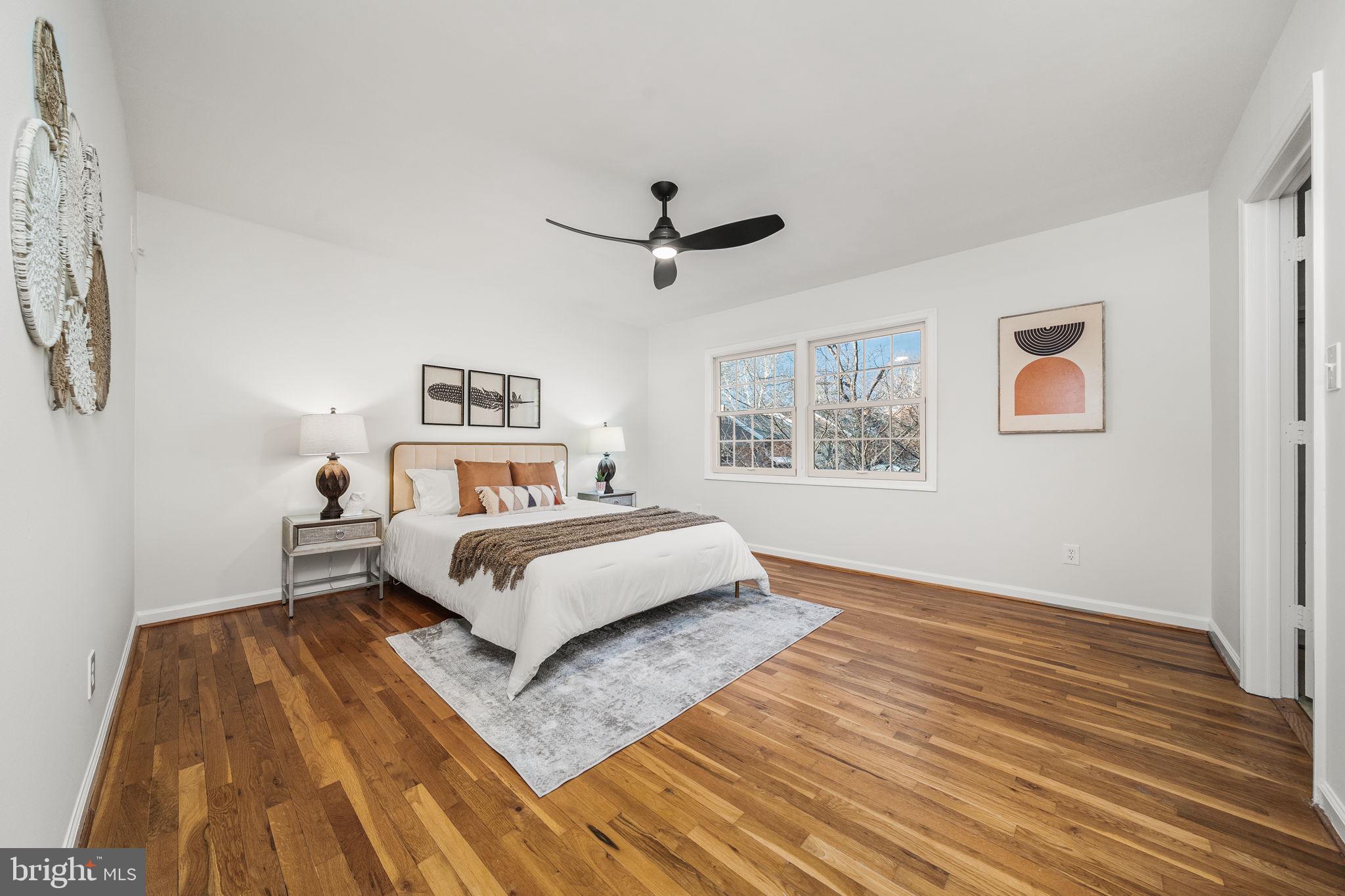 8333 Garfield Court Springfield, VA 22152 - Photo 26 of 60 a bedroom with a bed and wooden floor