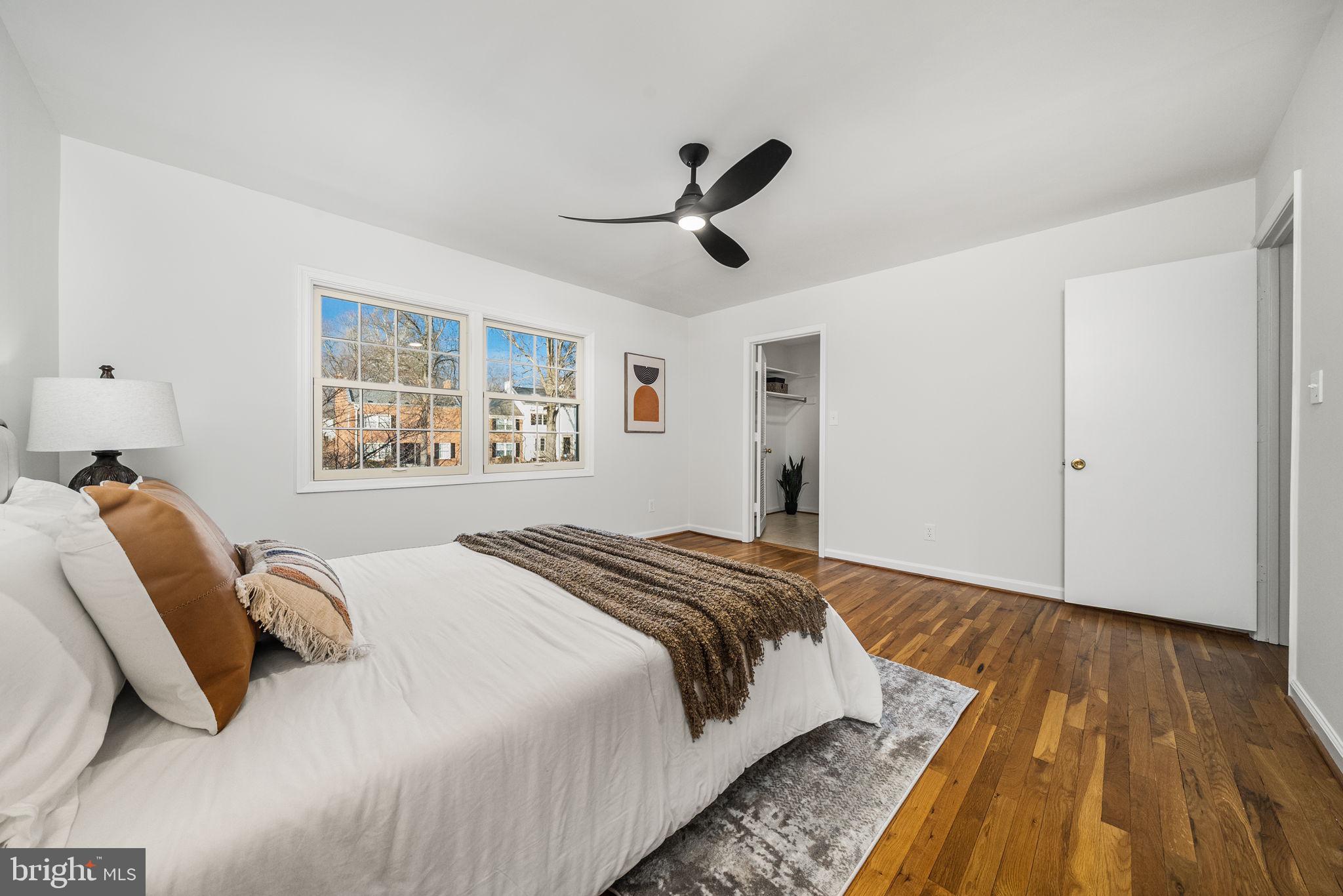 8333 Garfield Court Springfield, VA 22152 - Photo 27 of 60 a bedroom with a bed and wooden floor
