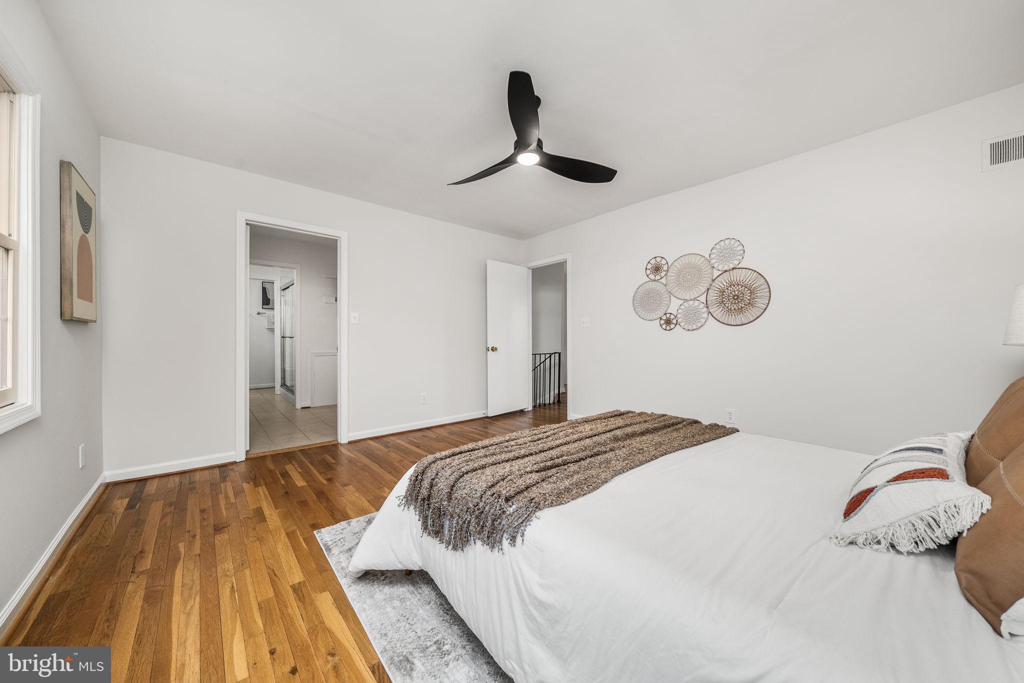 8333 Garfield Court Springfield, VA 22152 - Photo 28 of 60 a bedroom with a bed and a book shelf