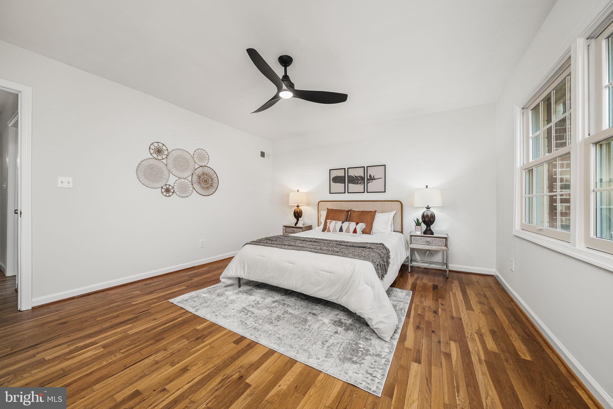 8333 Garfield Court Springfield, VA 22152 - Photo 29 of 60 a bedroom with a bed and wooden floor
