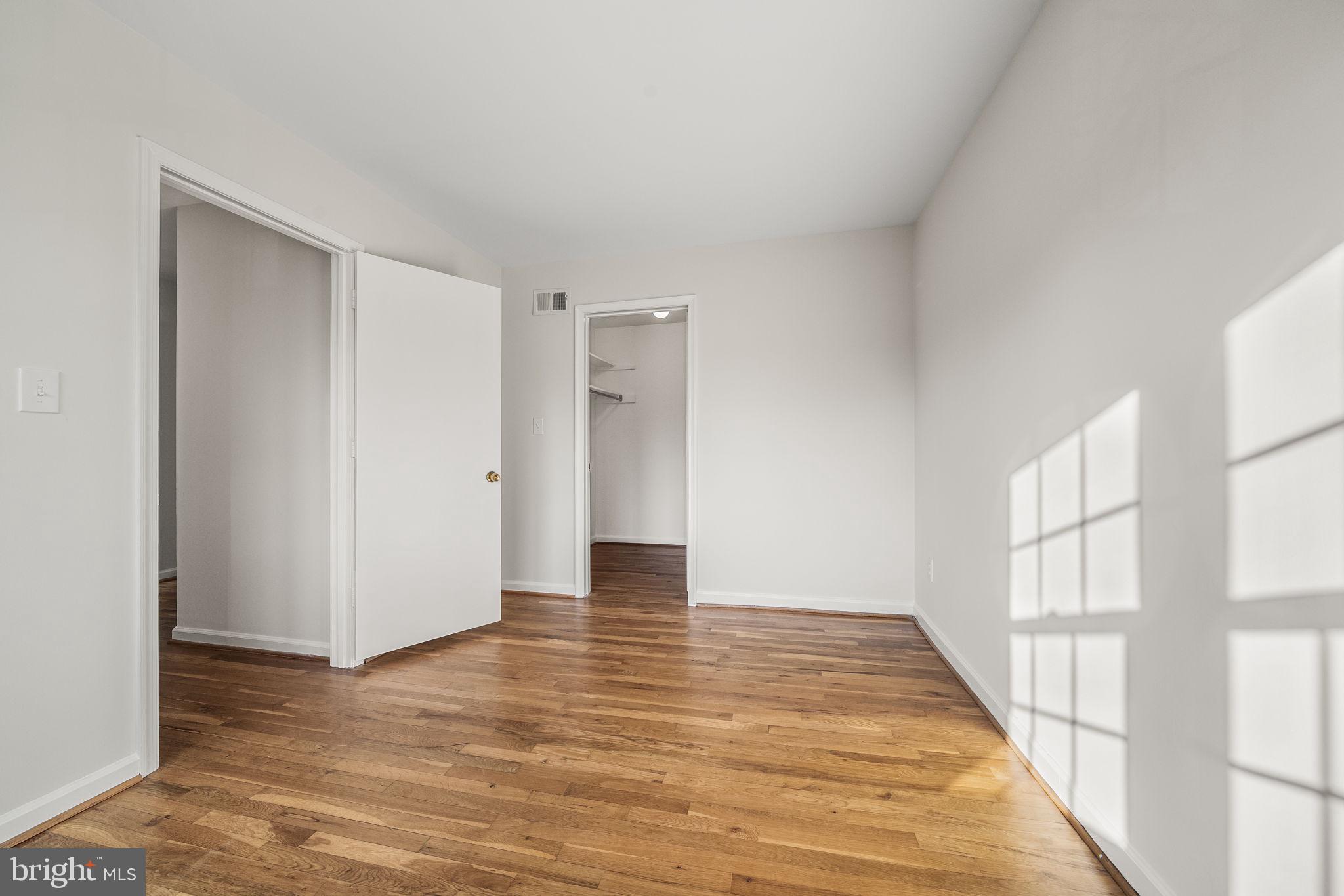 8333 Garfield Court Springfield, VA 22152 - Photo 38 of 60 a view of an empty room with wooden floor and a window