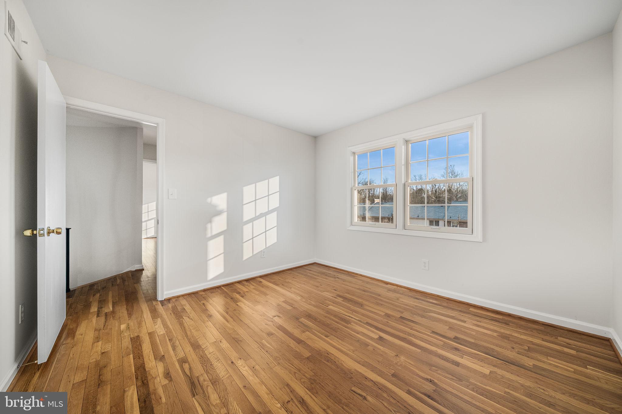 8333 Garfield Court Springfield, VA 22152 - Photo 40 of 60 wooden floor in an empty room with a window