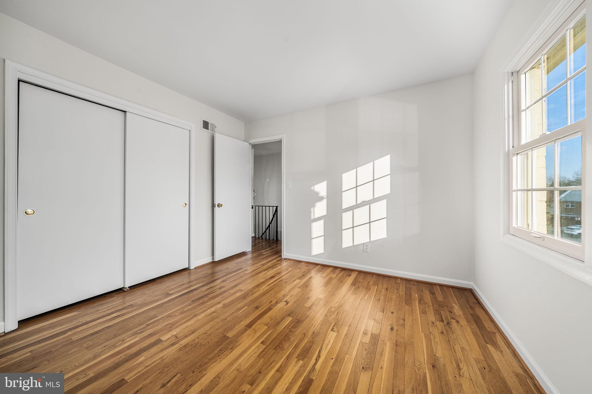8333 Garfield Court Springfield, VA 22152 - Photo 41 of 60 a view of an empty room with wooden floor and a window