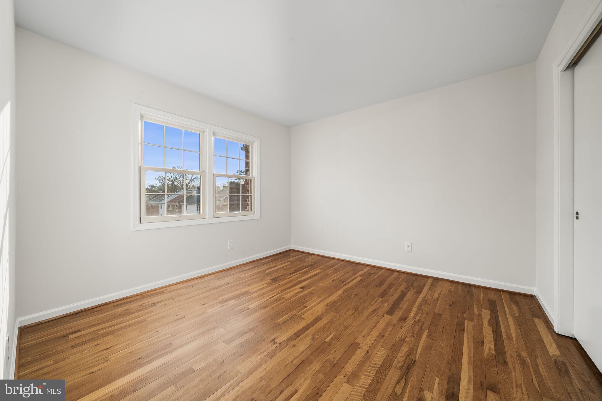 8333 Garfield Court Springfield, VA 22152 - Photo 42 of 60 a view of an empty room with wooden floor and a window