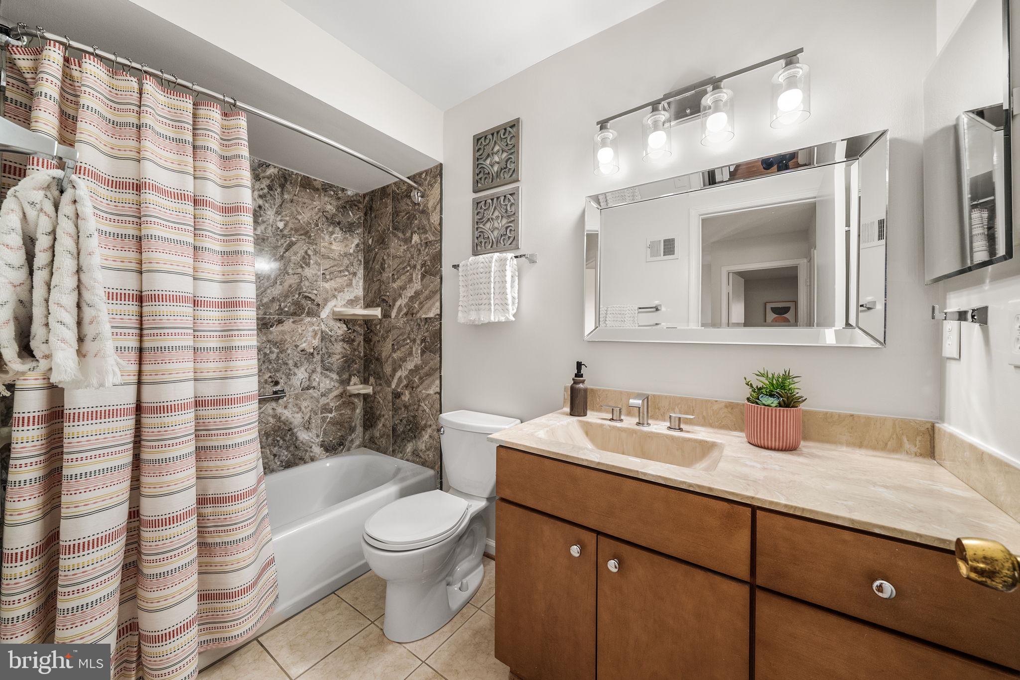 8333 Garfield Court Springfield, VA 22152 - Photo 43 of 60 a bathroom with a sink a toilet and shower