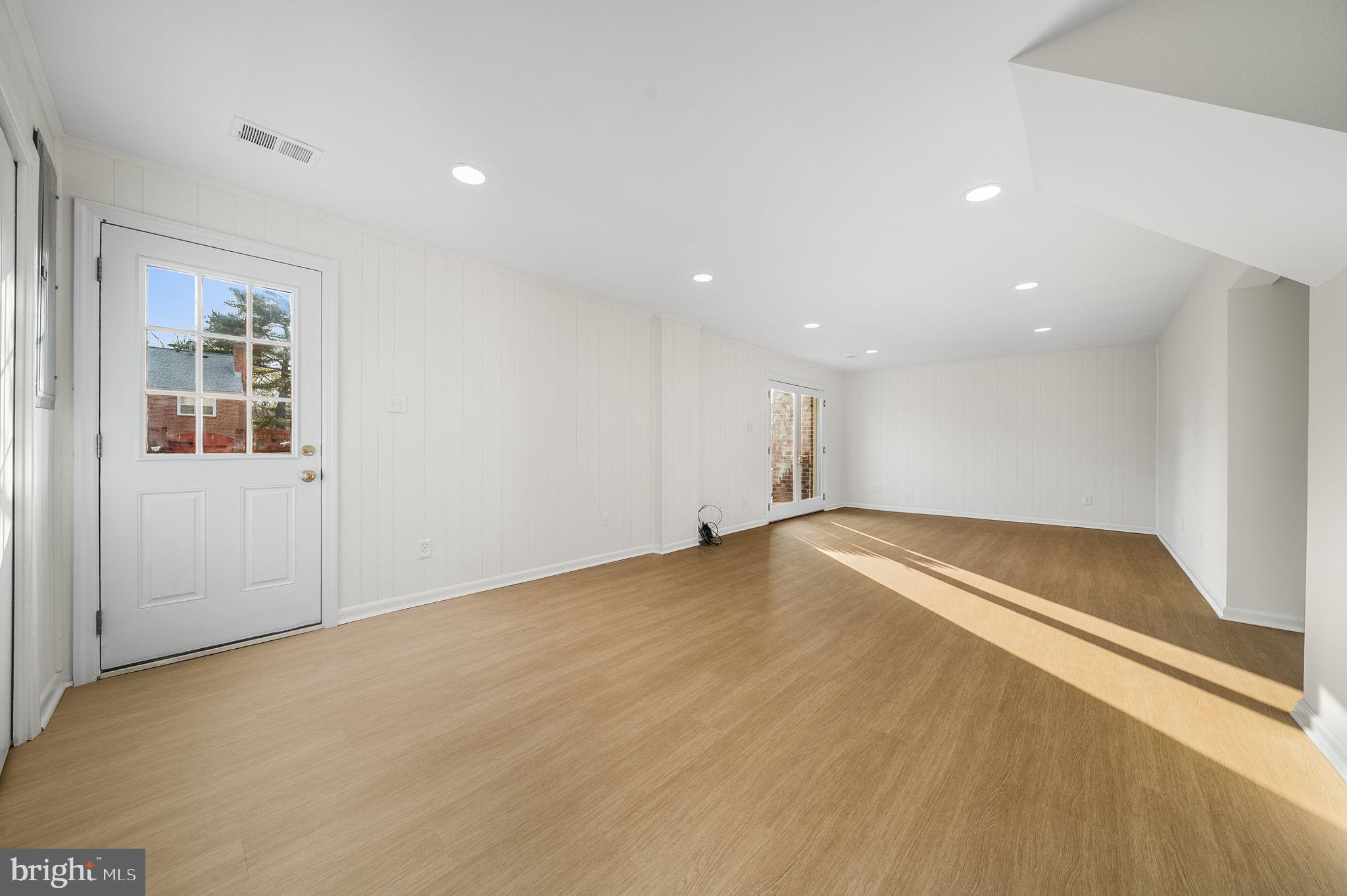 8333 Garfield Court Springfield, VA 22152 - Photo 47 of 60 a view of empty room with wooden floor and fan
