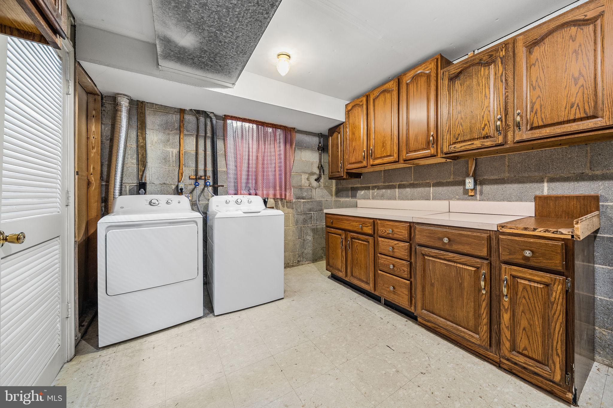 8333 Garfield Court Springfield, VA 22152 - Photo 50 of 60 a utility room with cabinets washer and dryer