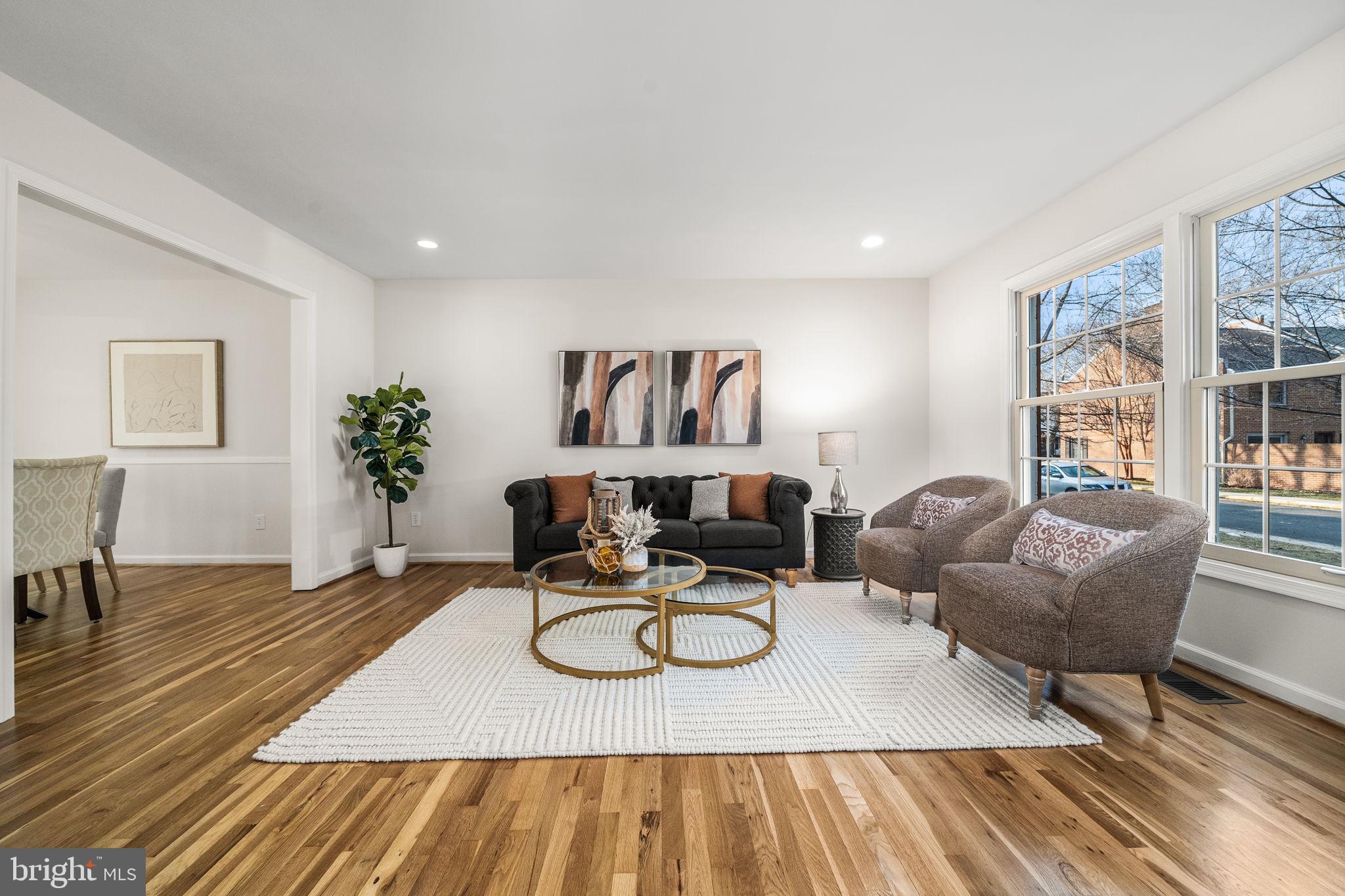 8333 Garfield Court Springfield, VA 22152 - Photo 9 of 60 a living room with furniture a rug potted plant and a window