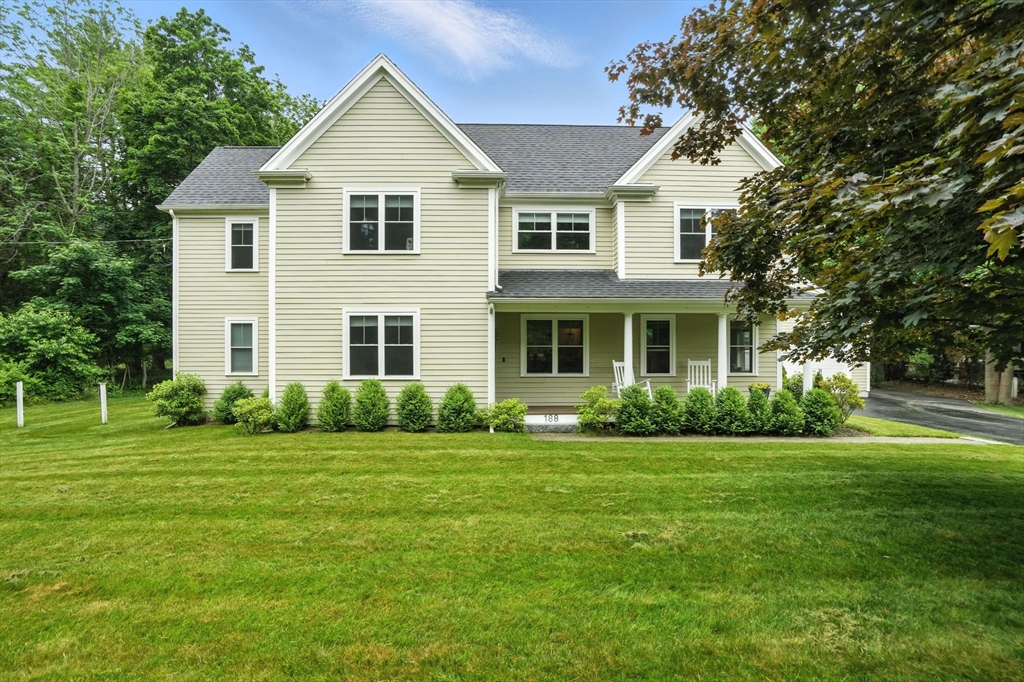 a front view of a house and a yard and trees
