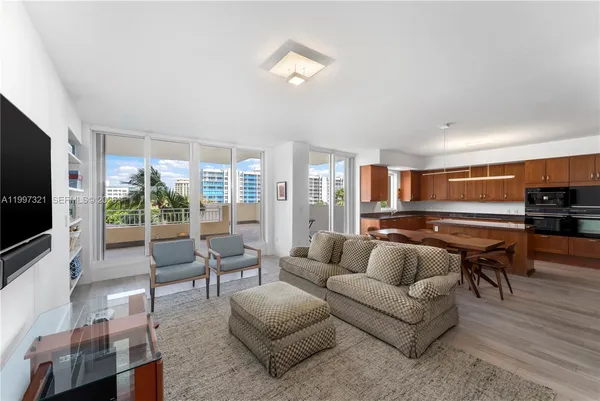 a kitchen with stainless steel appliances a dining table chairs and granite counter tops