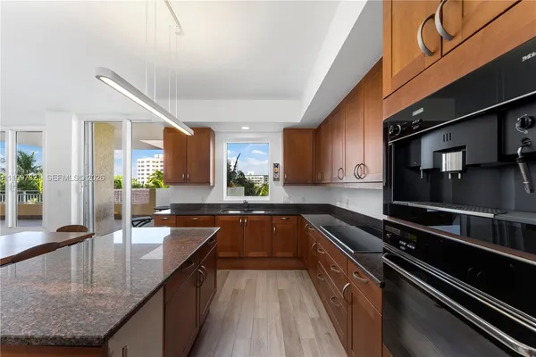 a kitchen with a wooden table and chairs