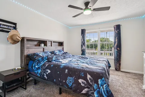 a bed sitting in a bedroom next to a window