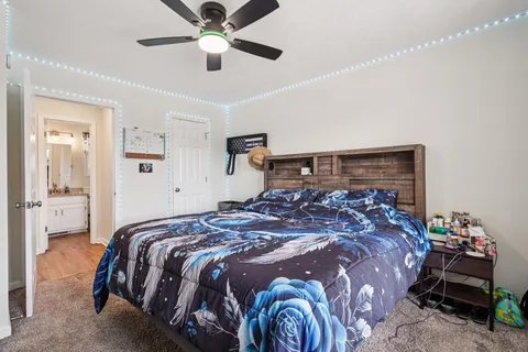 a bedroom with a bed and a chandelier