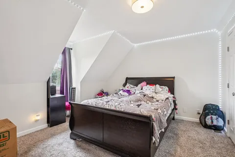 a bedroom with a bed and a baby crib