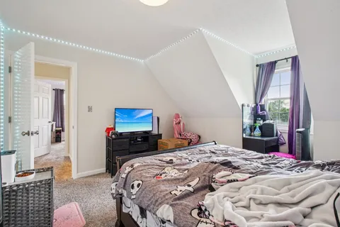 a bedroom with a bed and a flat screen tv