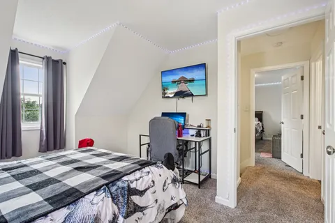 a bed room with a bed and a television