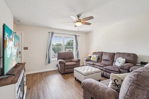 a living room with furniture and a flat screen tv