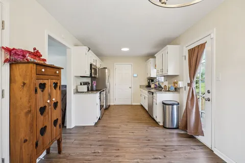 a kitchen with stainless steel appliances a refrigerator and a stove top oven