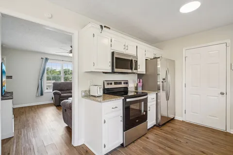 a kitchen with a stove a sink and a microwave