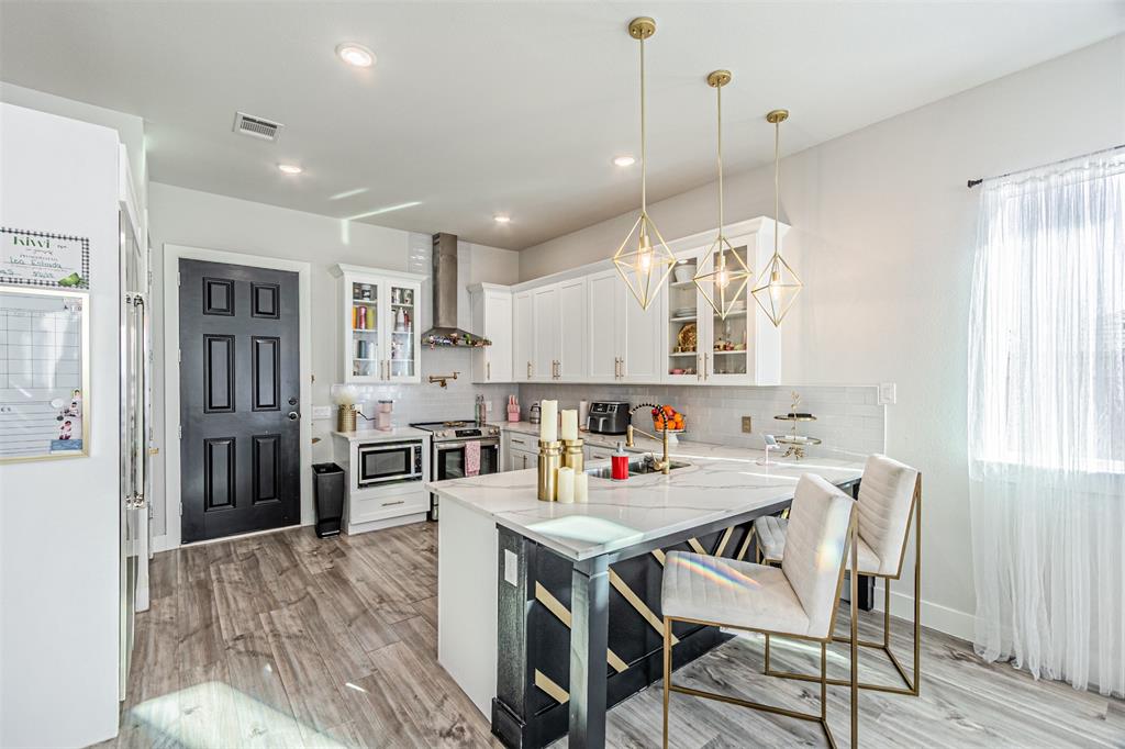 1503 Morrell Avenue Dallas, TX 75203 - Photo 11 of 30 a view of a dining room and livingroom with furniture wooden floor a chandelier