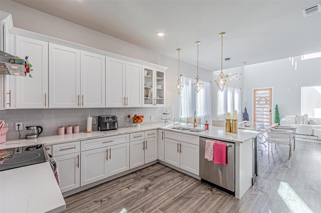 1503 Morrell Avenue Dallas, TX 75203 - Photo 13 of 30 a kitchen with kitchen island granite countertop a sink cabinets and wooden floor