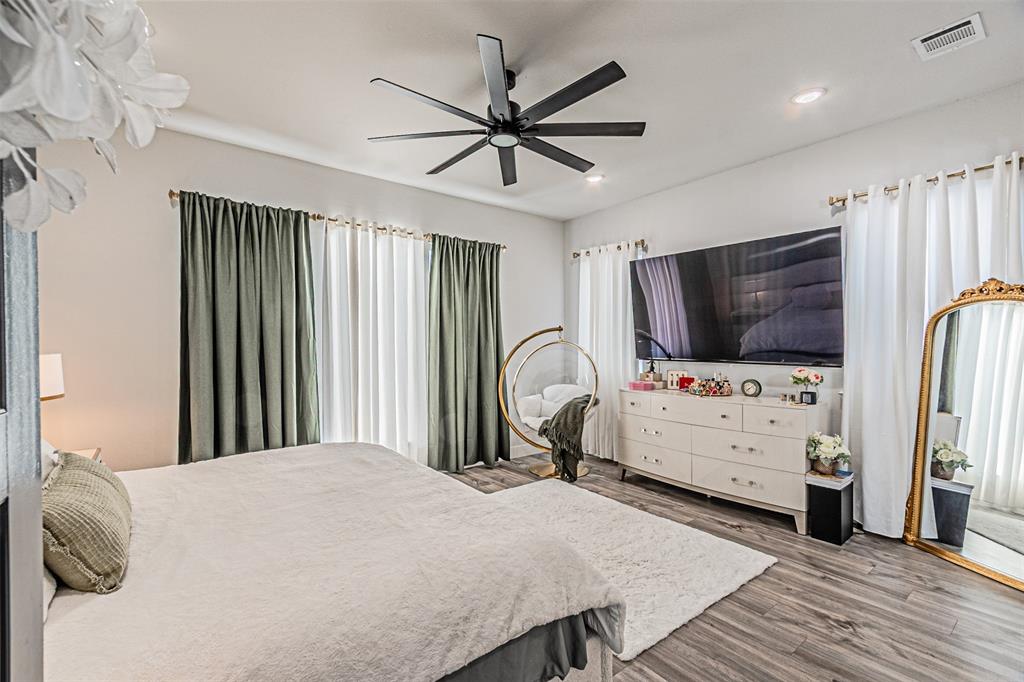 1503 Morrell Avenue Dallas, TX 75203 - Photo 15 of 30 a bedroom with furniture and flat screen tv