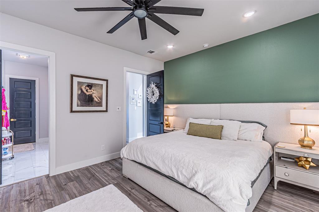 1503 Morrell Avenue Dallas, TX 75203 - Photo 16 of 30 a bedroom with a bed and a chandelier