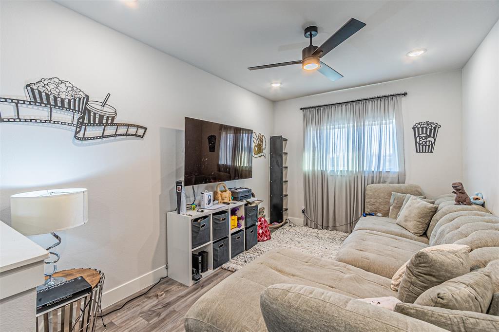 1503 Morrell Avenue Dallas, TX 75203 - Photo 19 of 30 a bedroom with furniture and a flat screen tv