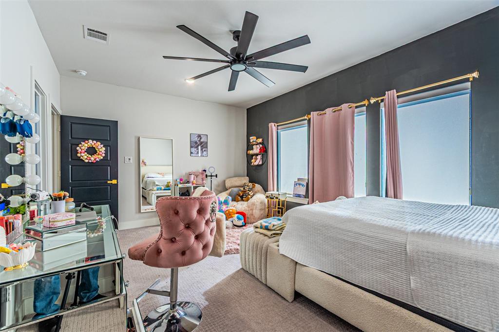 1503 Morrell Avenue Dallas, TX 75203 - Photo 21 of 30 a bedroom with a bed and a chandelier