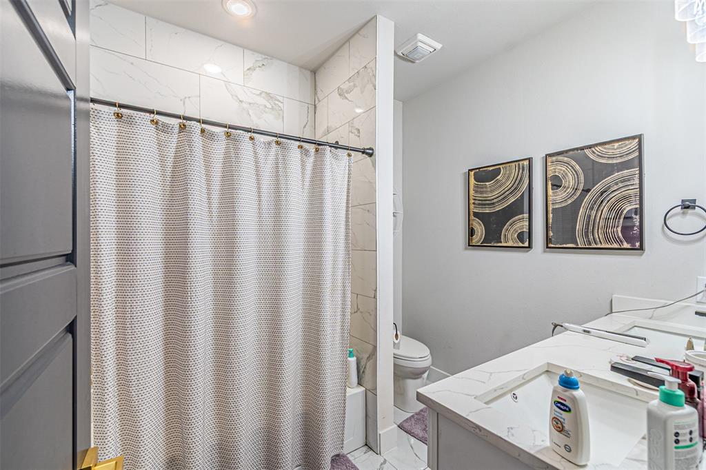 1503 Morrell Avenue Dallas, TX 75203 - Photo 25 of 30 a bathroom with a sink and a shower curtain