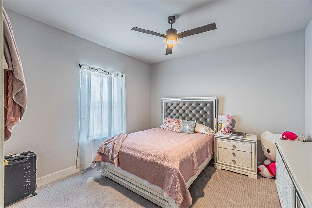 1503 Morrell Avenue Dallas, TX 75203 - Photo 26 of 30 a bedroom with a bed and a chandelier
