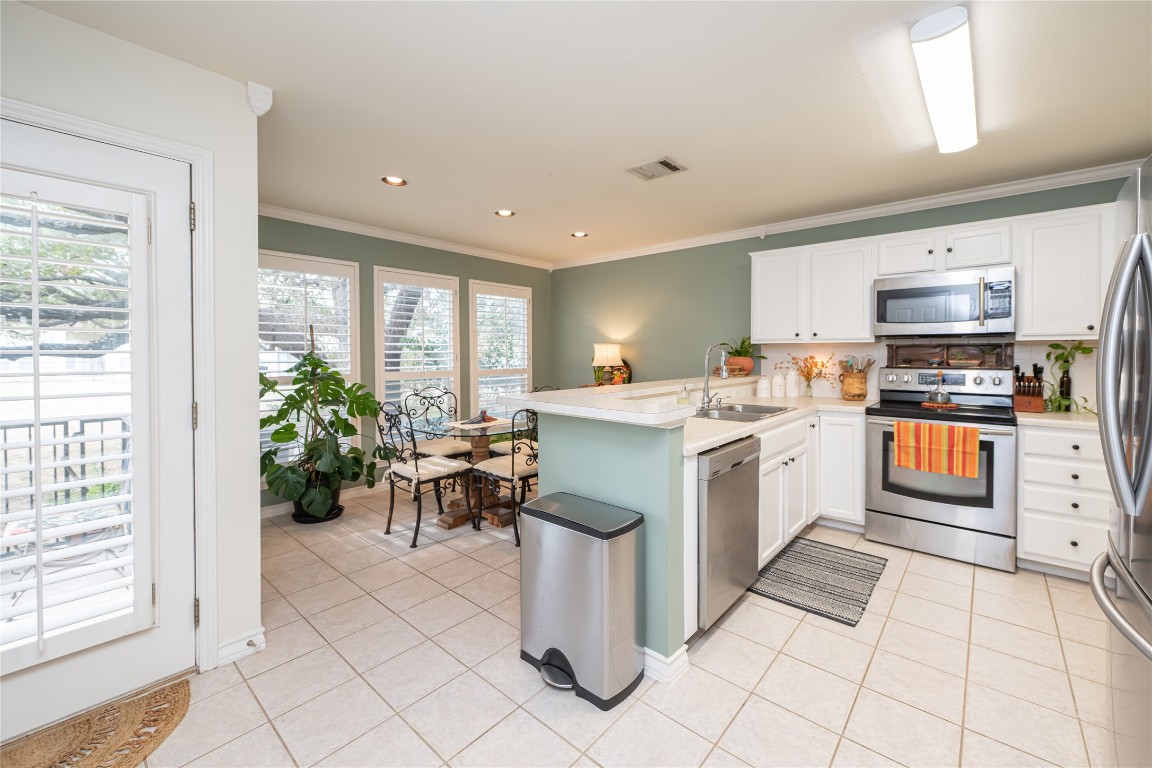 5402 Beacon Drive, Unit A Austin, TX 78734 - Photo 13 of 40 a kitchen with a sink and cabinets