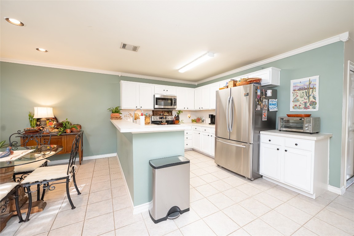 5402 Beacon Drive, Unit A Austin, TX 78734 - Photo 14 of 40 a kitchen with a refrigerator a stove top oven and kitchen island
