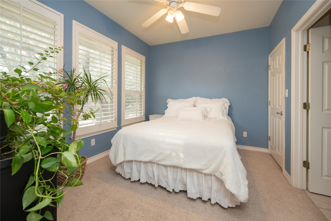 5402 Beacon Drive, Unit A Austin, TX 78734 - Photo 26 of 40 a spacious bedroom with a bed and a window