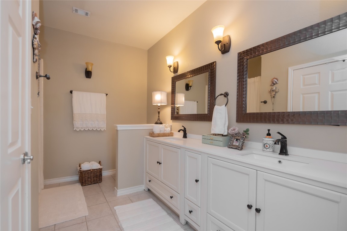 5402 Beacon Drive, Unit A Austin, TX 78734 - Photo 30 of 40 a bathroom with a double vanity sink mirror and