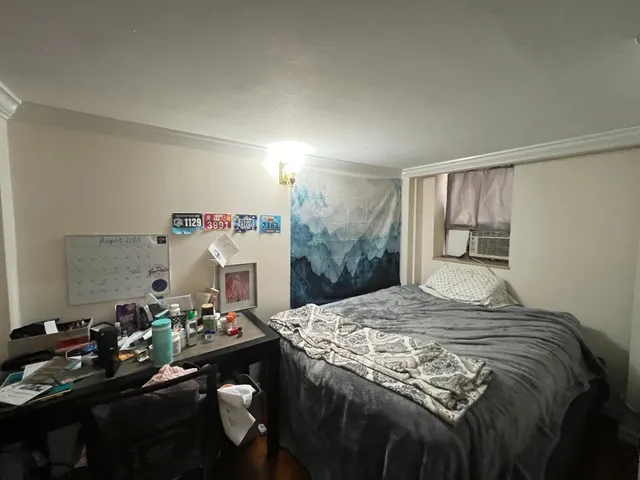 a bedroom with a bed and a dresser