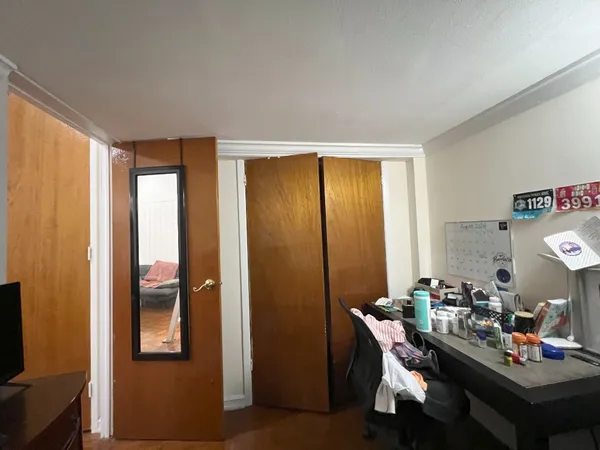 a view of a workspace with furniture and a window