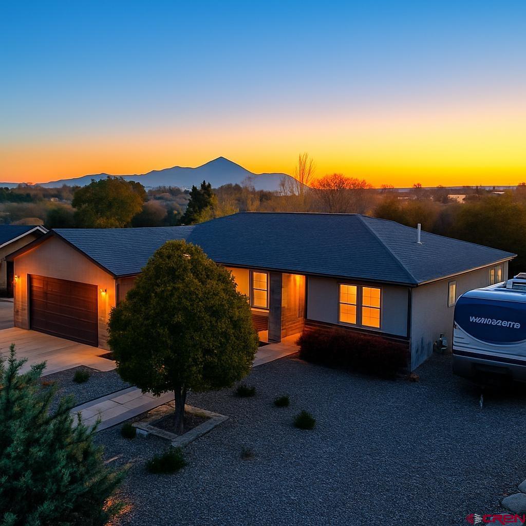 a view of a house with a yard and sitting area