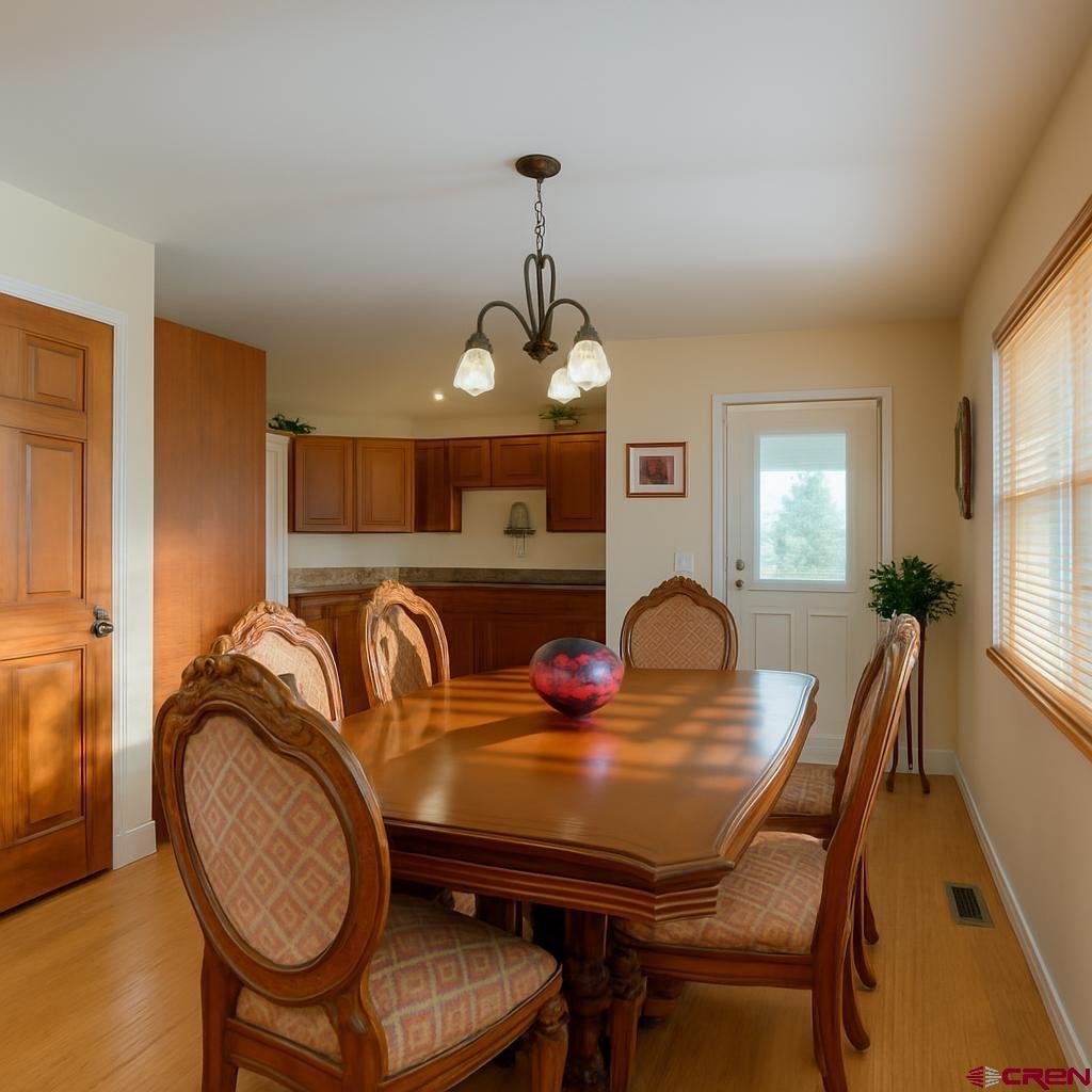 1711 Golf Course Lane Cortez, CO 81321 - Photo 16 of 45 a dining room with furniture and window
