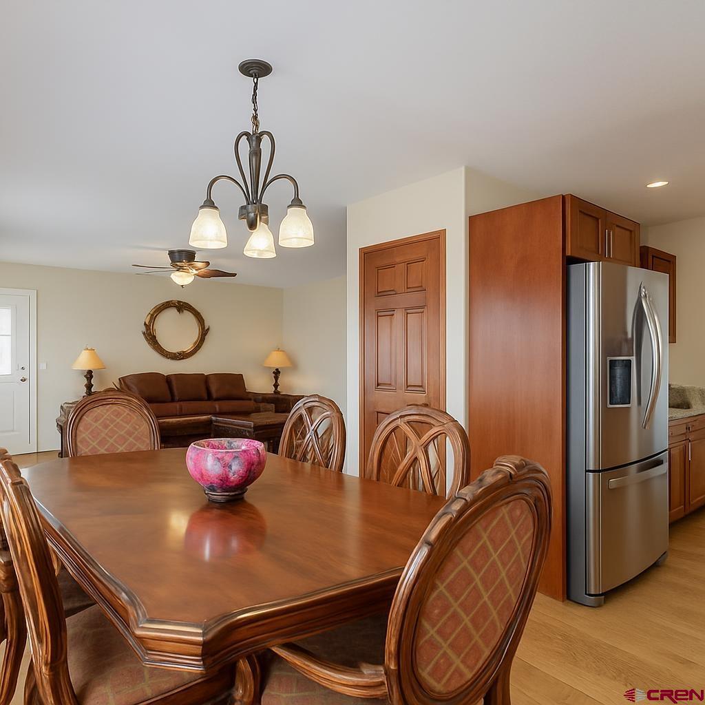 1711 Golf Course Lane Cortez, CO 81321 - Photo 17 of 45 a kitchen with stainless steel appliances granite countertop a dining table and chairs