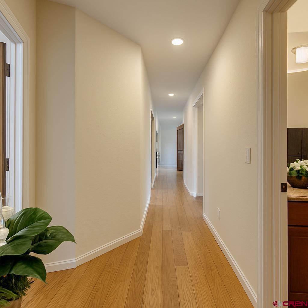1711 Golf Course Lane Cortez, CO 81321 - Photo 23 of 45 a view of a hallway with wooden floor