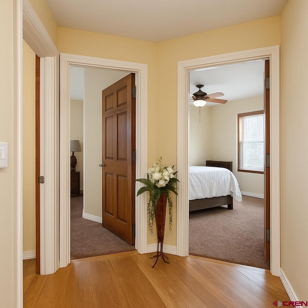 1711 Golf Course Lane Cortez, CO 81321 - Photo 25 of 45 a bedroom with a bed and a mirror