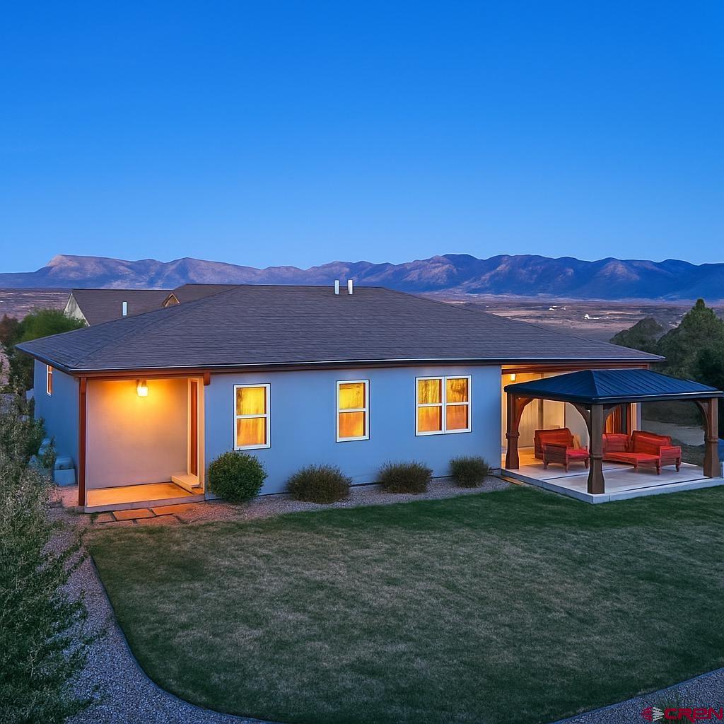 1711 Golf Course Lane Cortez, CO 81321 - Photo 5 of 45 a view of house with a yard and a large tree