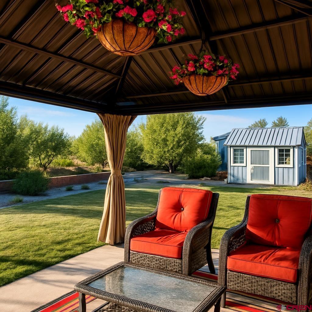 1711 Golf Course Lane Cortez, CO 81321 - Photo 10 of 45 a view of a chairs and table in patio with a fire pit