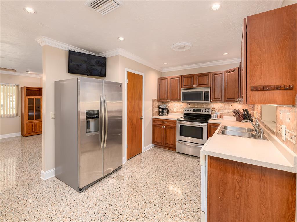 907 Hillside Terrace Brandon, FL 33511 - Photo 11 of 35 a kitchen with stainless steel appliances a refrigerator stove microwave and sink
