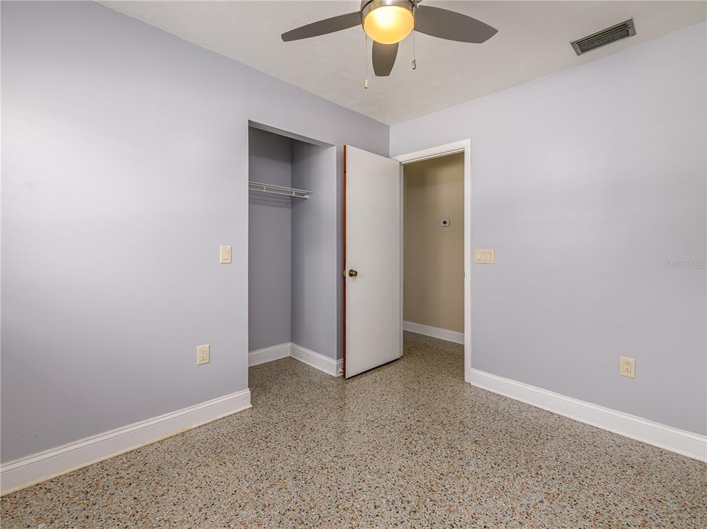 907 Hillside Terrace Brandon, FL 33511 - Photo 26 of 35 an empty room with a mirror and fan