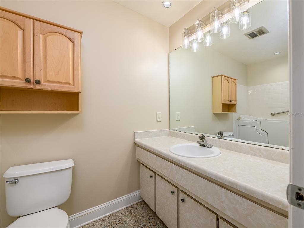 907 Hillside Terrace Brandon, FL 33511 - Photo 27 of 35 a bathroom with a sink a toilet and mirror